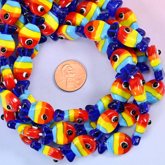 Colorful Fish glass bead strands coiled around a US penny for size reference