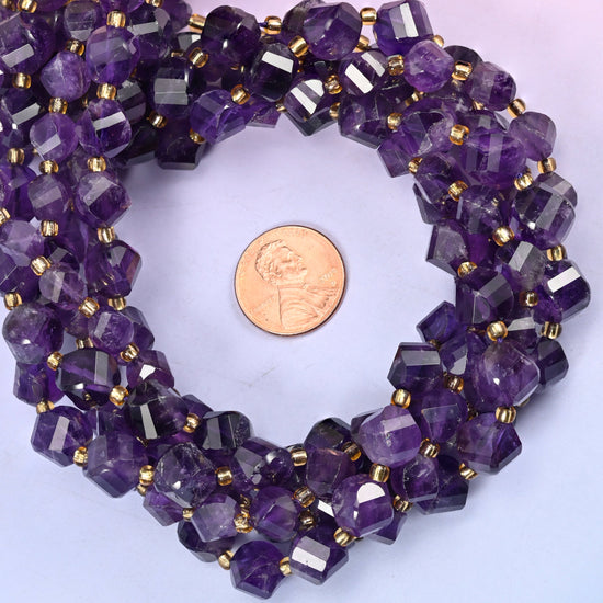 Dark Purple Amethyst faceted spiral twist bead strands coiled around a US penny for size reference