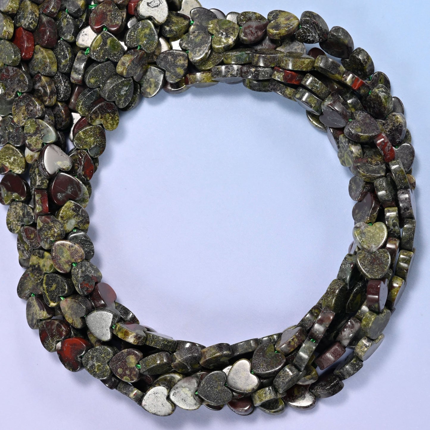 Dragon Bloodstone flat heart beads, close view of the coiled strands in mottled dark green with red-brown markings