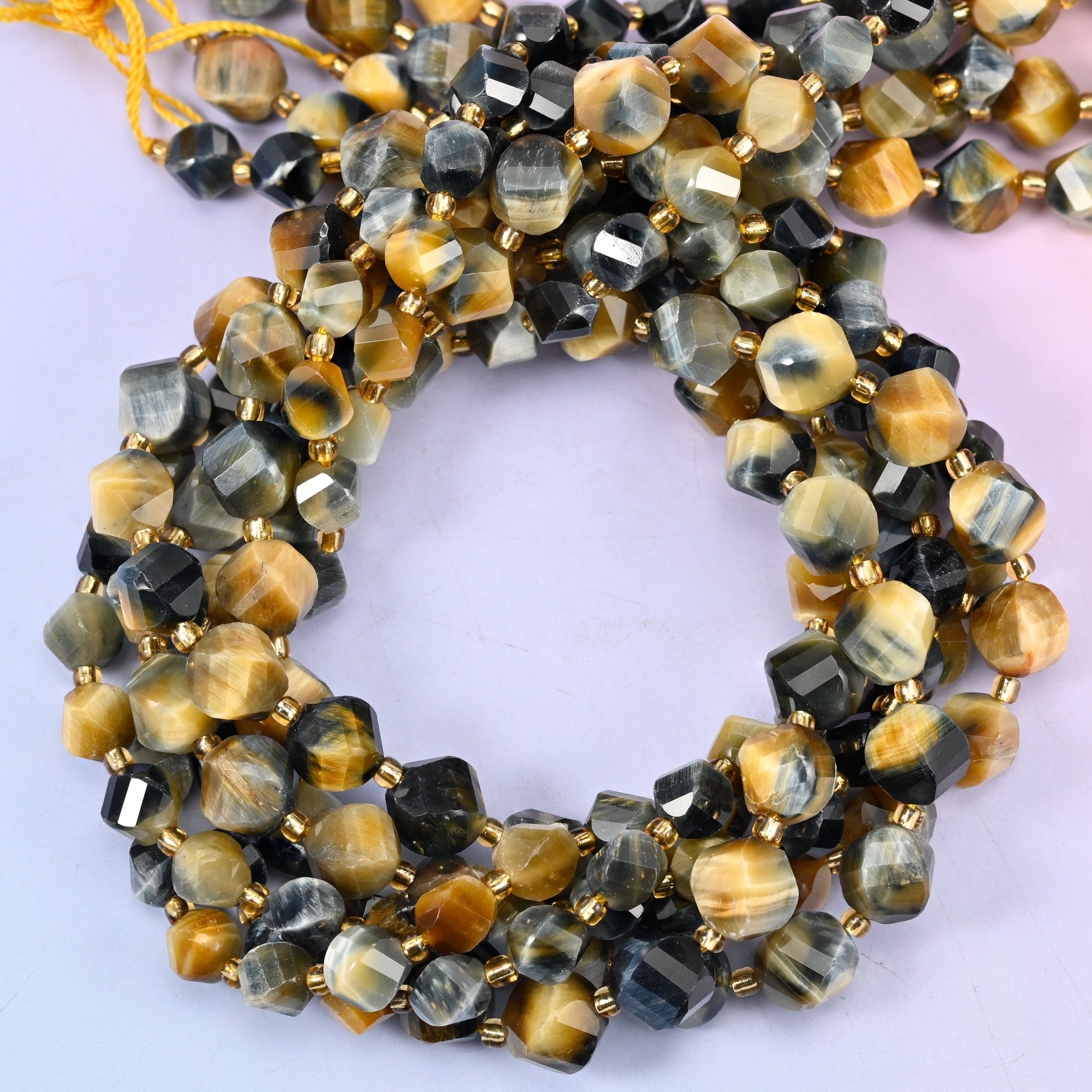 Dream Tiger Eye faceted spiral twist beads, close view of the coiled strands showing honey gold banded with blue-grey and black