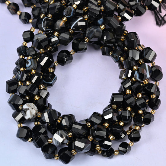 Dyed Black Strip Agate faceted spiral twist beads, close view of the coiled strands showing glossy black with white banded stripes