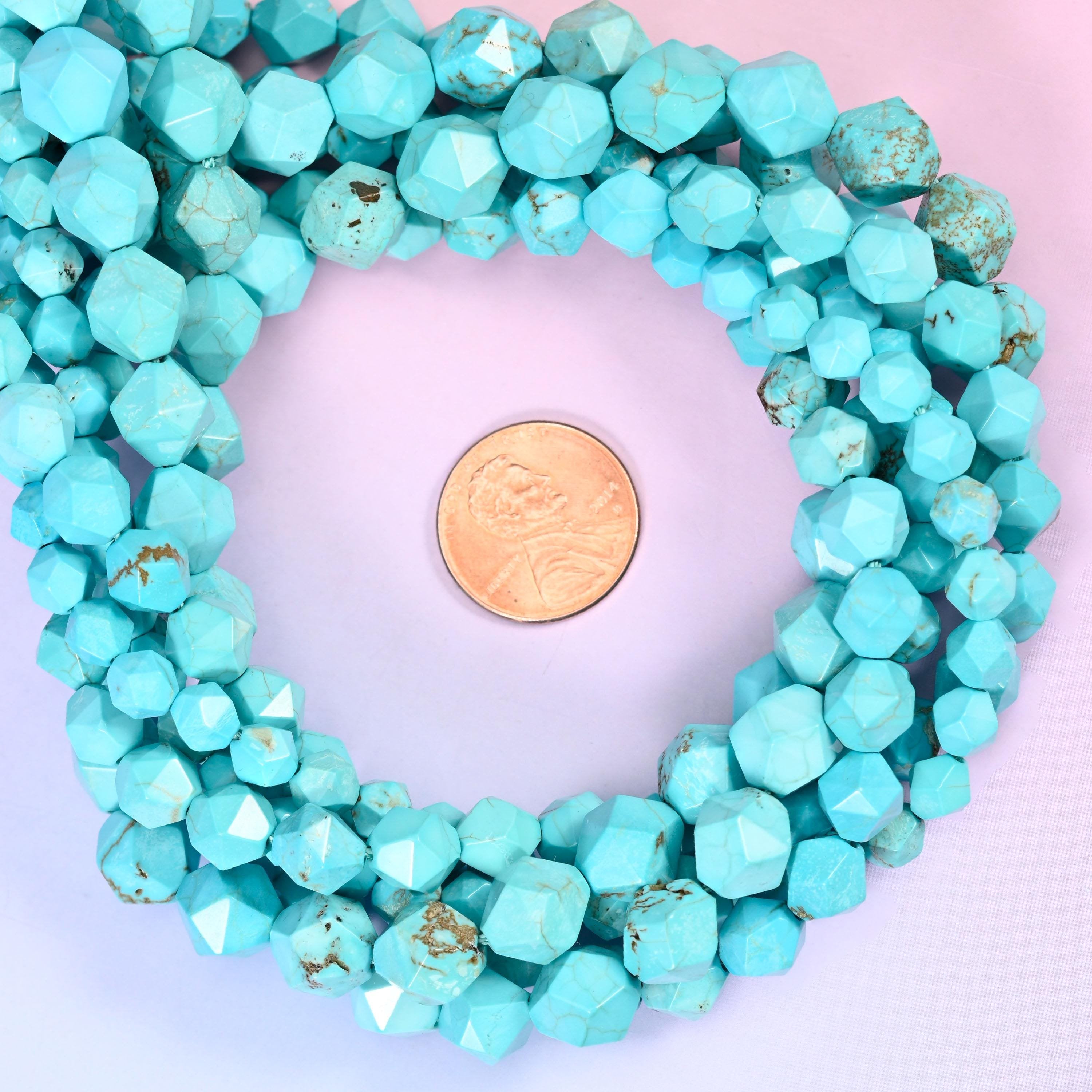 Dyed blue howlite faceted diamond star cut bead strands coiled around a US penny for size reference