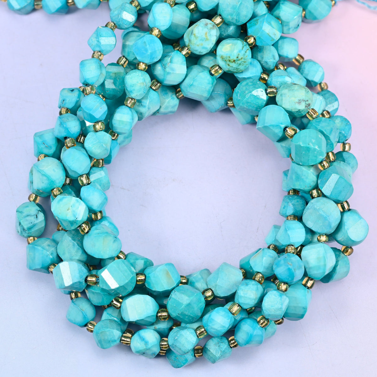 Dyed Lake Blue Howlite faceted spiral twist beads, close view of the coiled strands in turquoise blue with darker veining