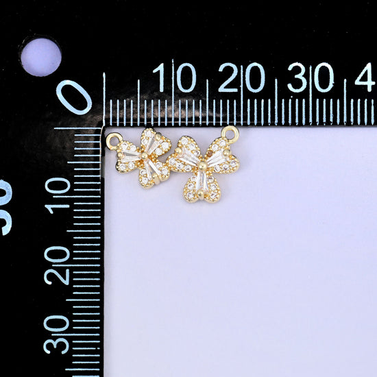 A flower zircon connector pendant photographed beside a millimetre ruler for scale