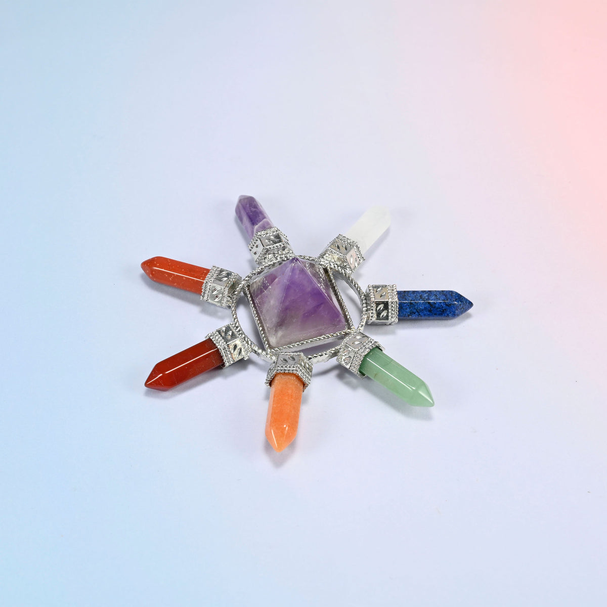 Crystal energy generator with a purple amethyst center pyramid and seven chakra crystal points in a silver-tone frame