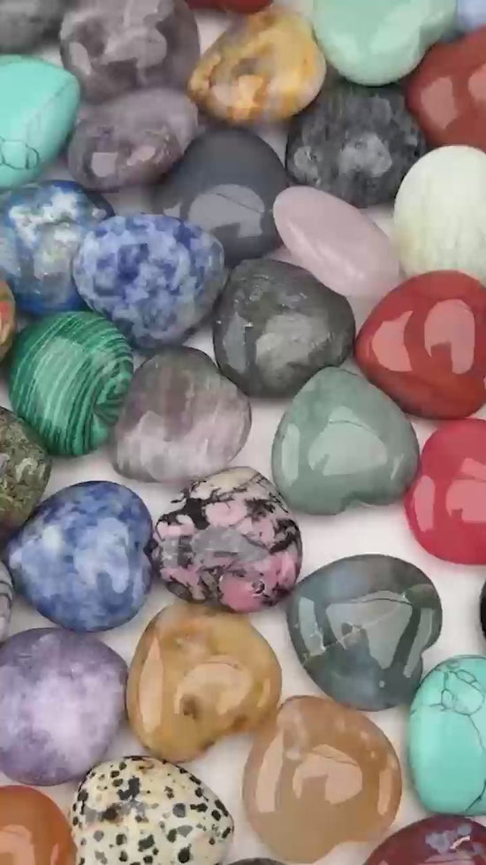 Polished 30mm gemstone hearts in mixed stones, shown loose in a pile