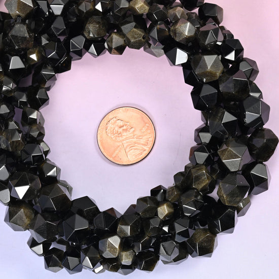 Gold obsidian faceted diamond star cut bead strands coiled around a US penny for size reference