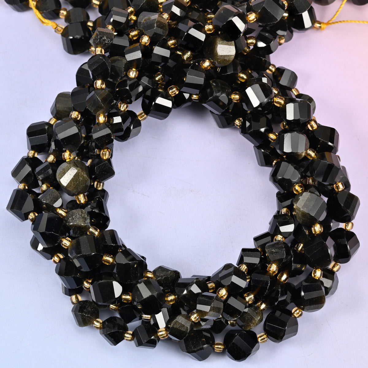 Gold Obsidian faceted spiral twist beads, close view of the coiled strands showing black with a golden sheen