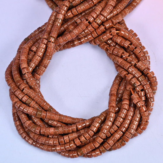 Gold Sandstone smooth heishi disc beads, close view of the coiled strands showing the copper-brown colour with fine glittering flecks