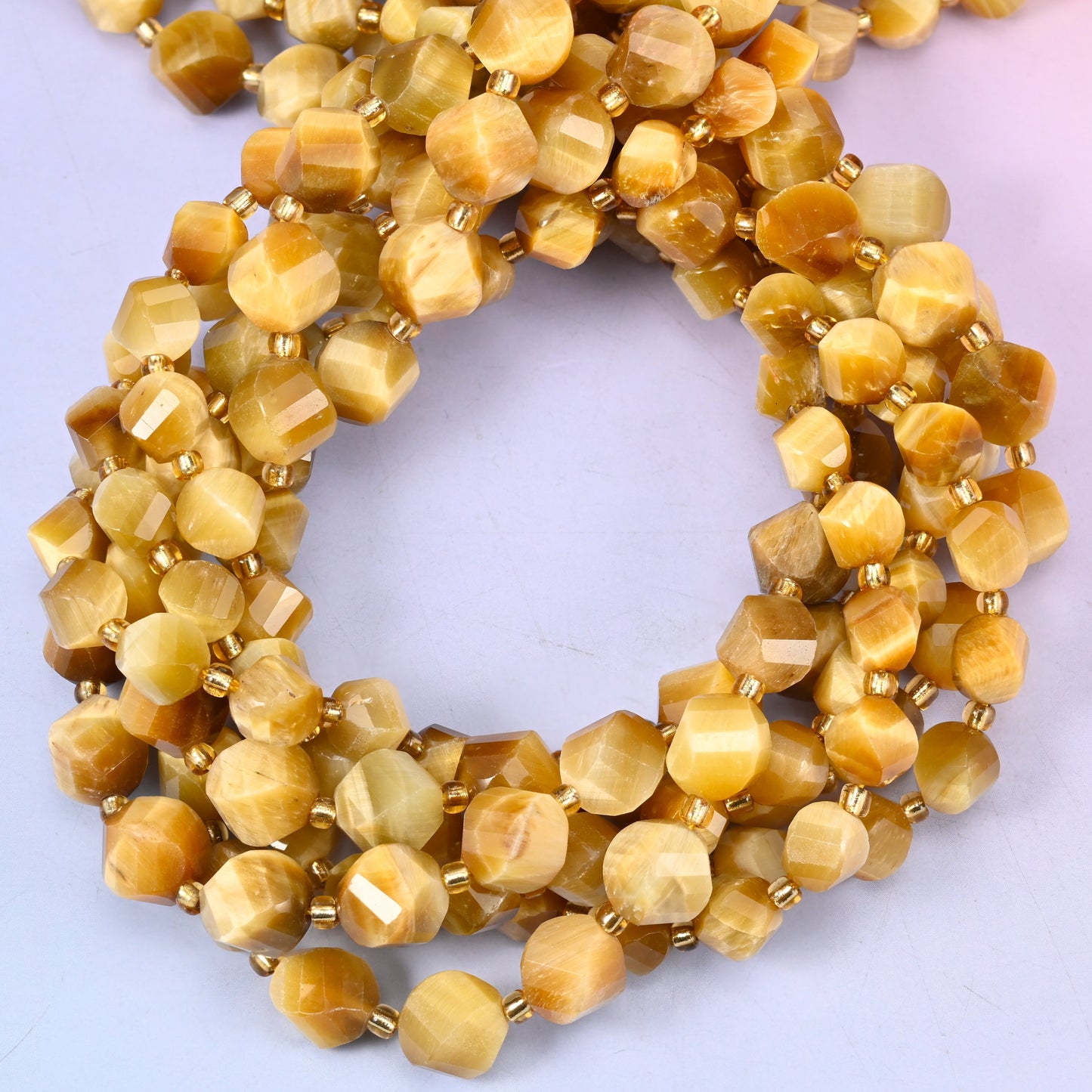 Gold Tiger Eye faceted spiral twist beads, close view of the coiled strands showing honey gold with a silky chatoyant sheen