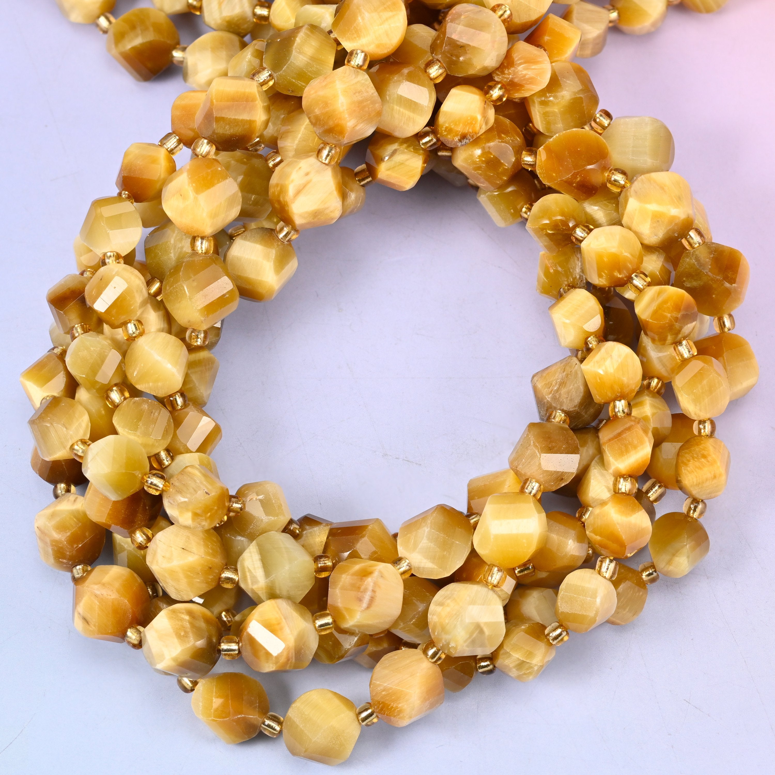 Gold Tiger Eye faceted spiral twist beads, close view of the coiled strands showing honey gold with a silky chatoyant sheen
