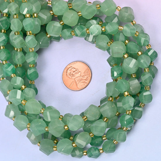 Green Aventurine faceted spiral twist bead strands coiled around a US penny for size reference