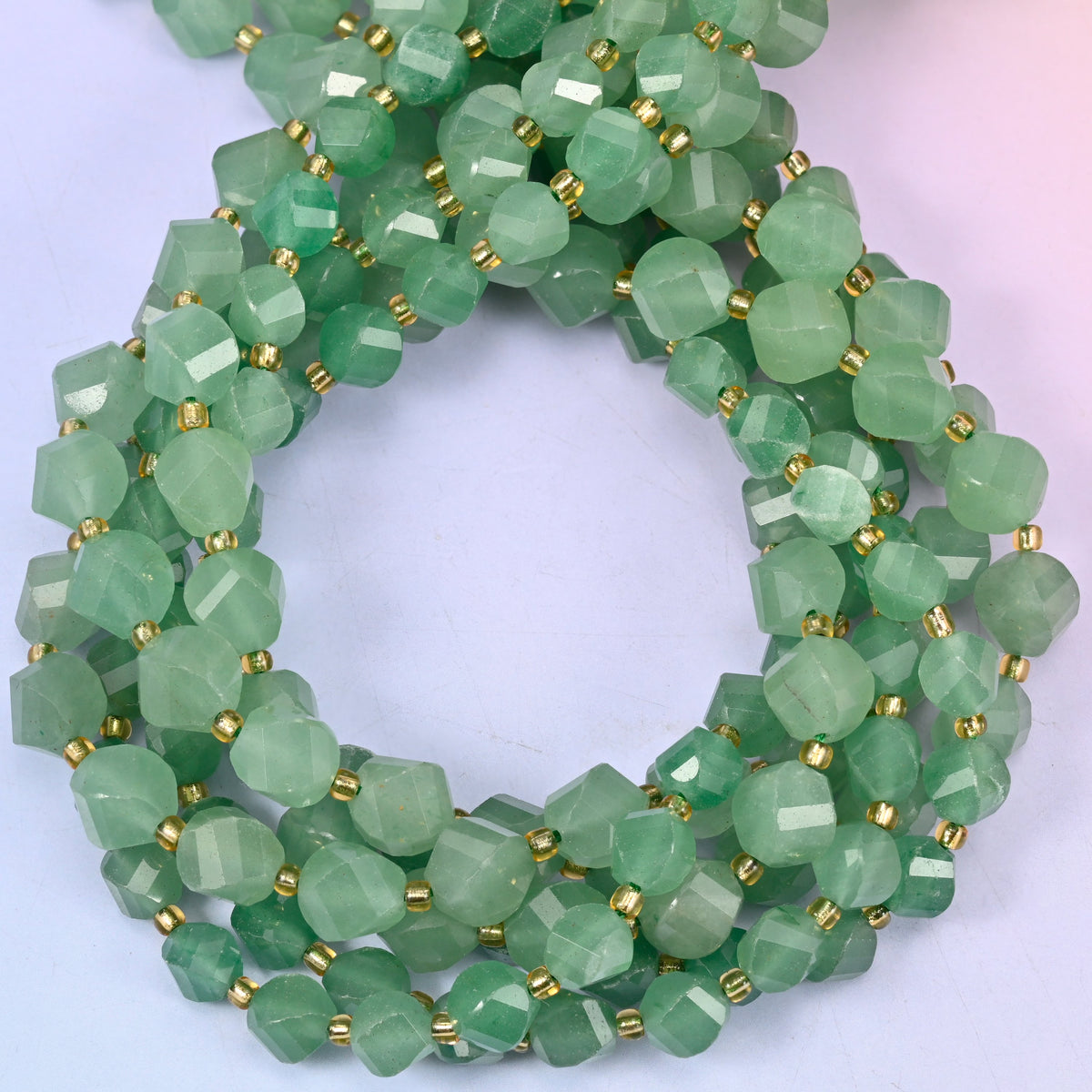 Green Aventurine faceted spiral twist beads, close view of the coiled strands showing the even mid-green colour