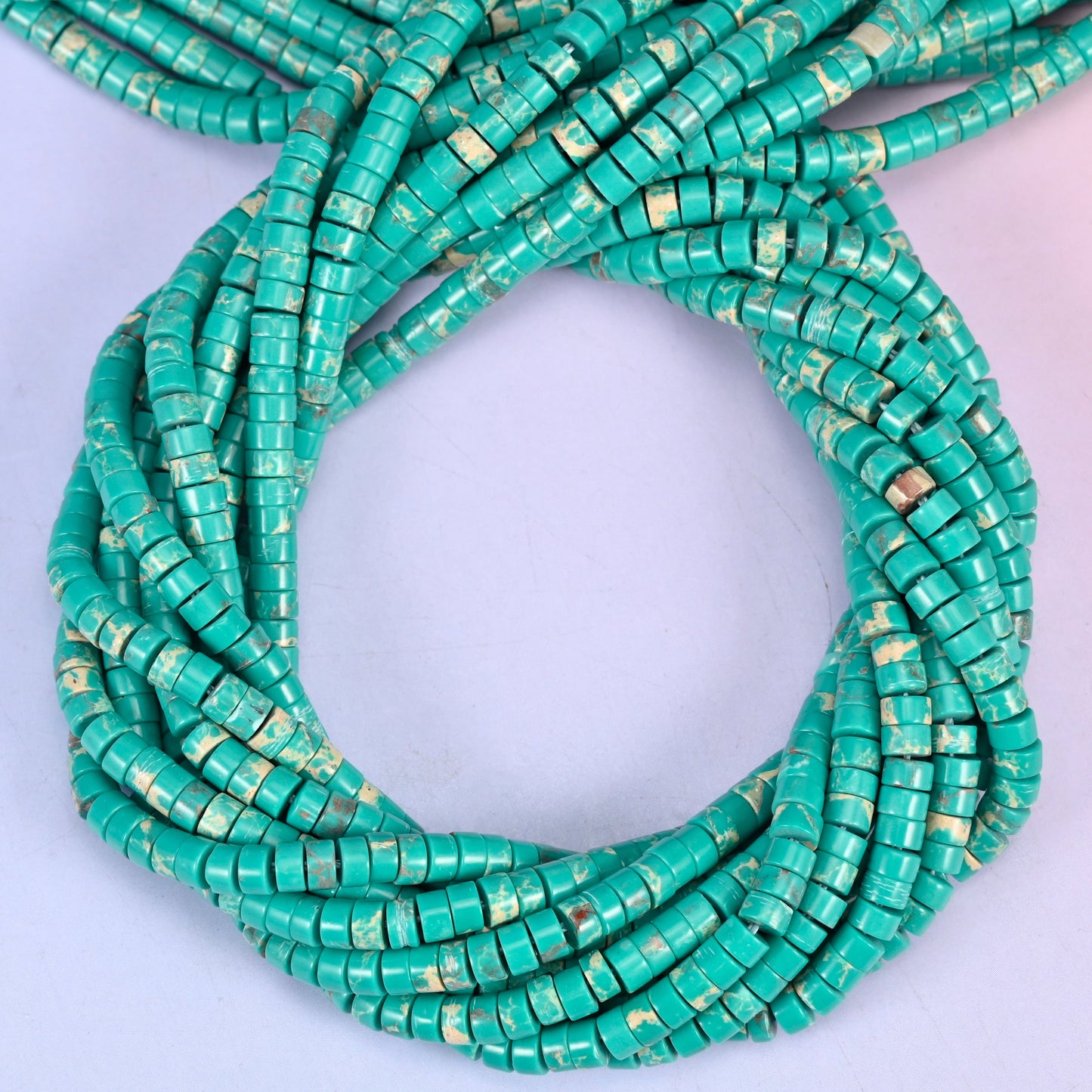 Green Shoushan Stone smooth heishi disc beads, close view of the coiled strands showing turquoise green with tan matrix flecks