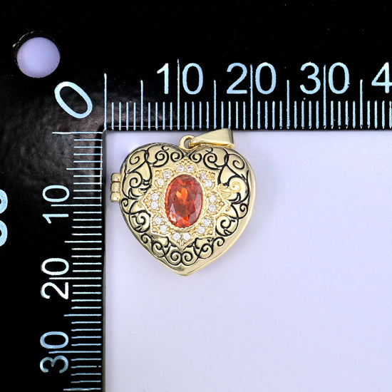 A heart locket zircon charm photographed beside a millimetre ruler for scale