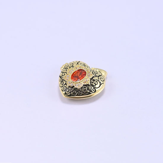 A heart locket charm with a filigree front and an orange oval stone, shown alone on a lilac background