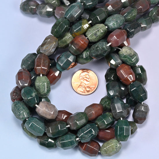 Indian Agate faceted barrel bead strands coiled around a US penny for size reference