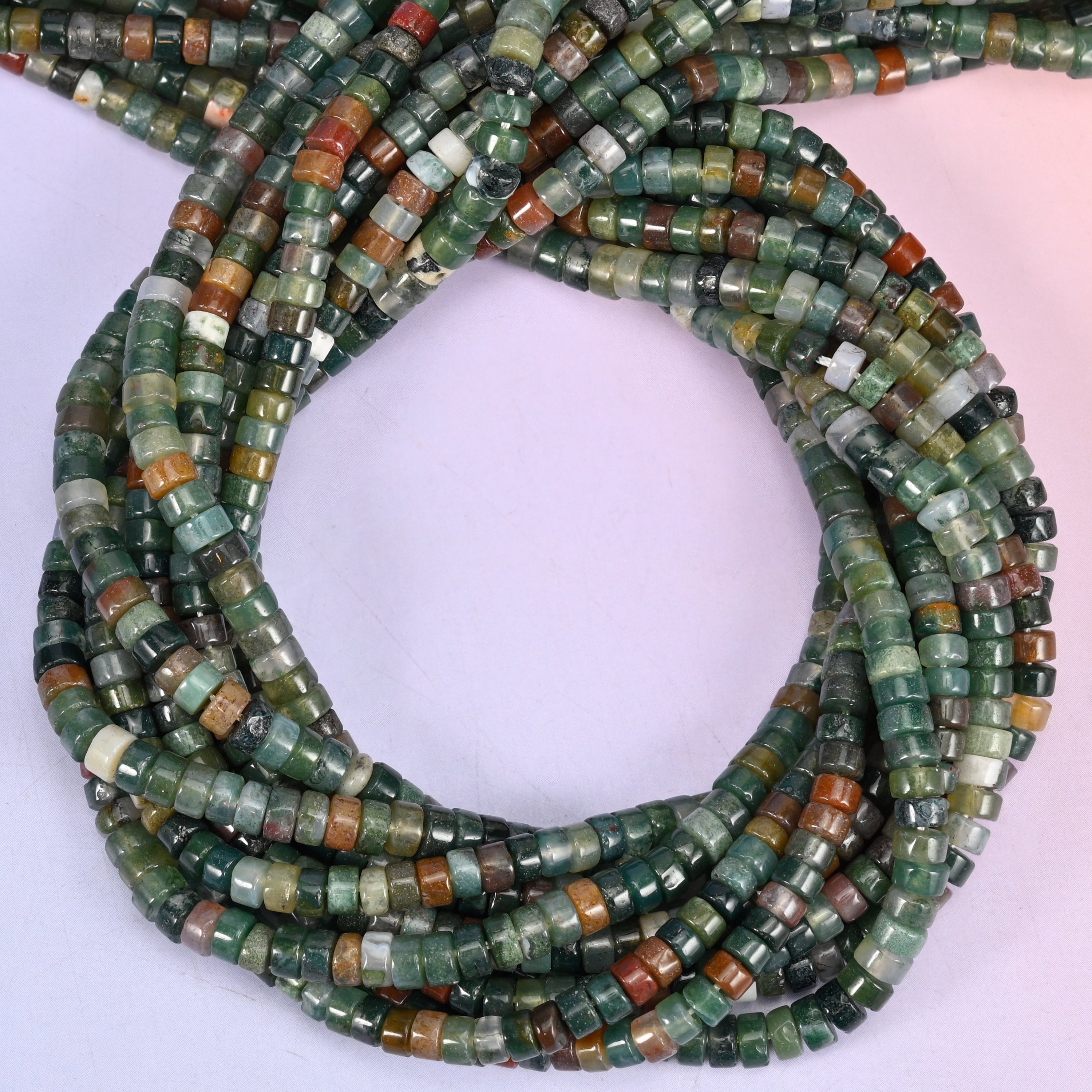 Indian Agate smooth heishi disc beads, close view of the coiled strands mixing green, rust and cream
