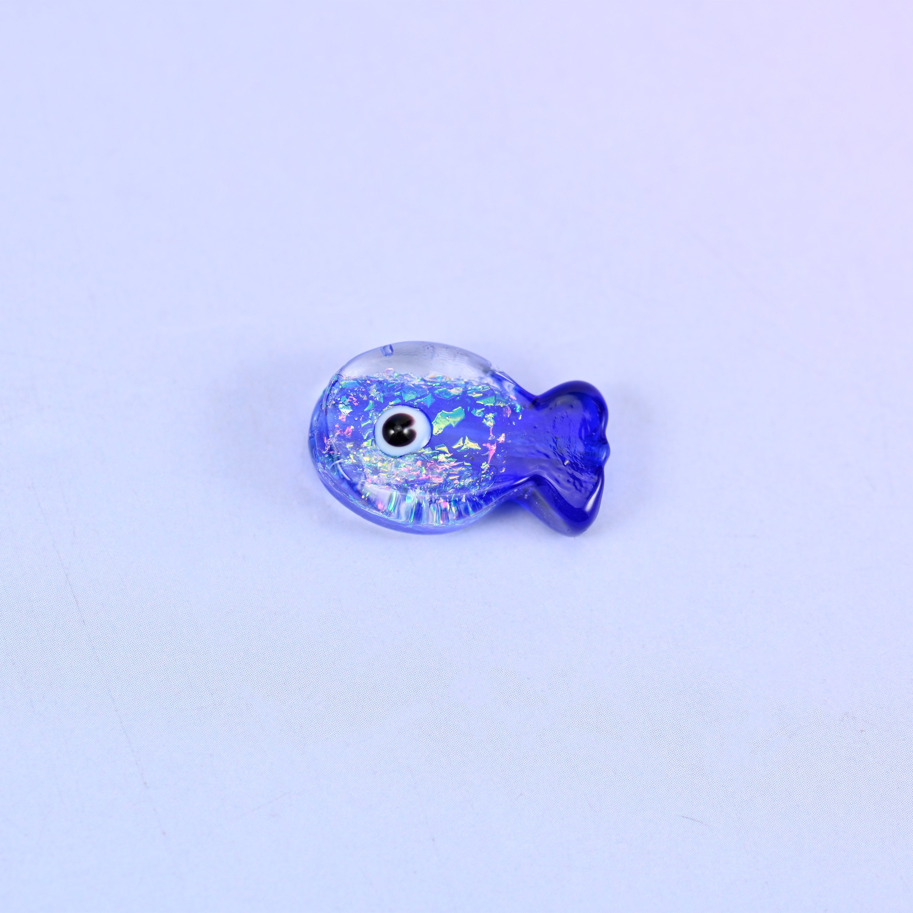 Single Iridescent Dark Blue Fish glass bead shown alone, showing the fish shape and the glitter inclusions in cobalt blue glass