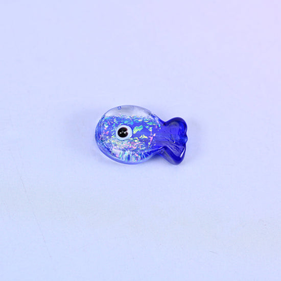 Single Iridescent Dark Blue Fish glass bead shown alone, showing the fish shape and the glitter inclusions in cobalt blue glass