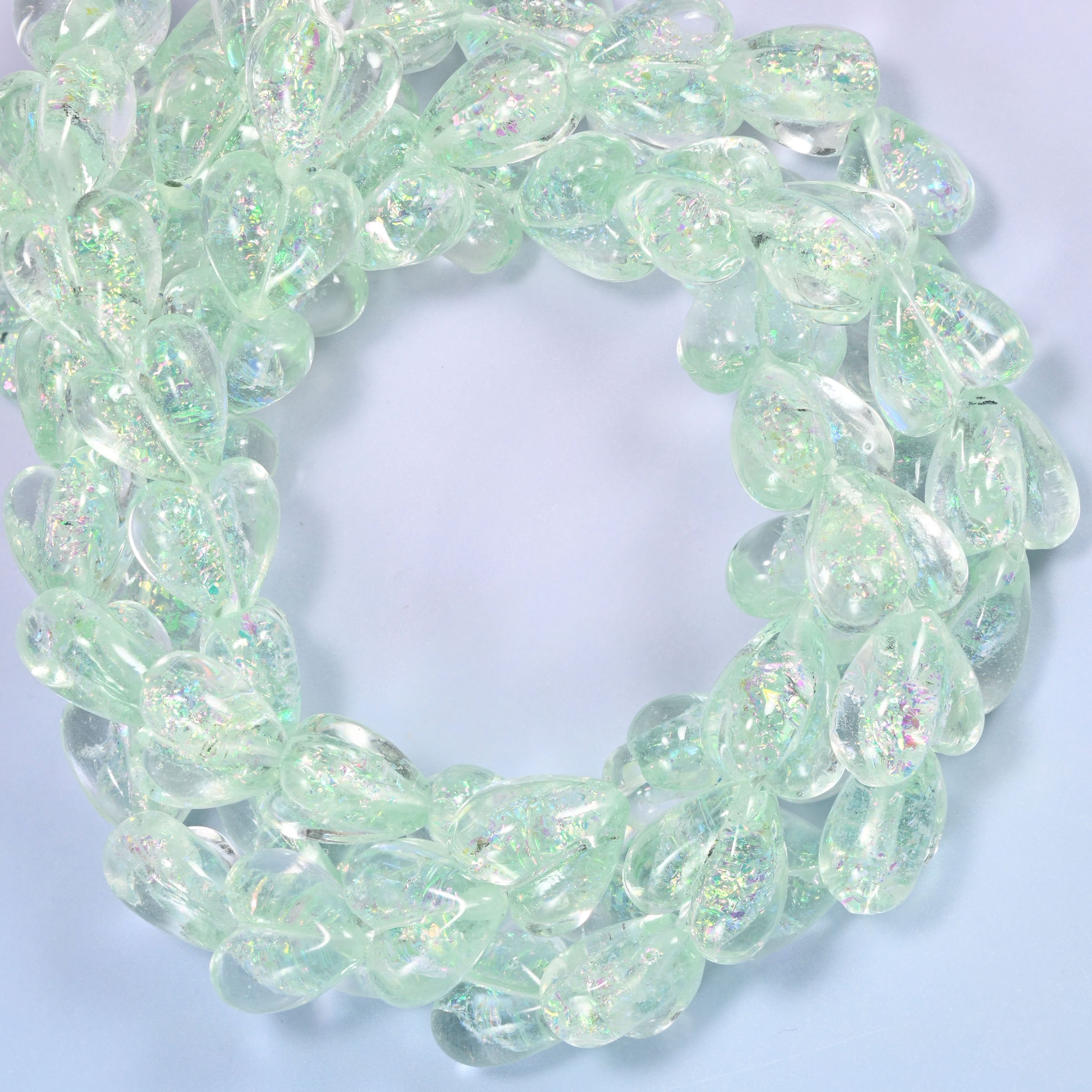 Iridescent Light Green Heart glass beads, close view of the coiled strands in frosted mint green with glitter inclusions