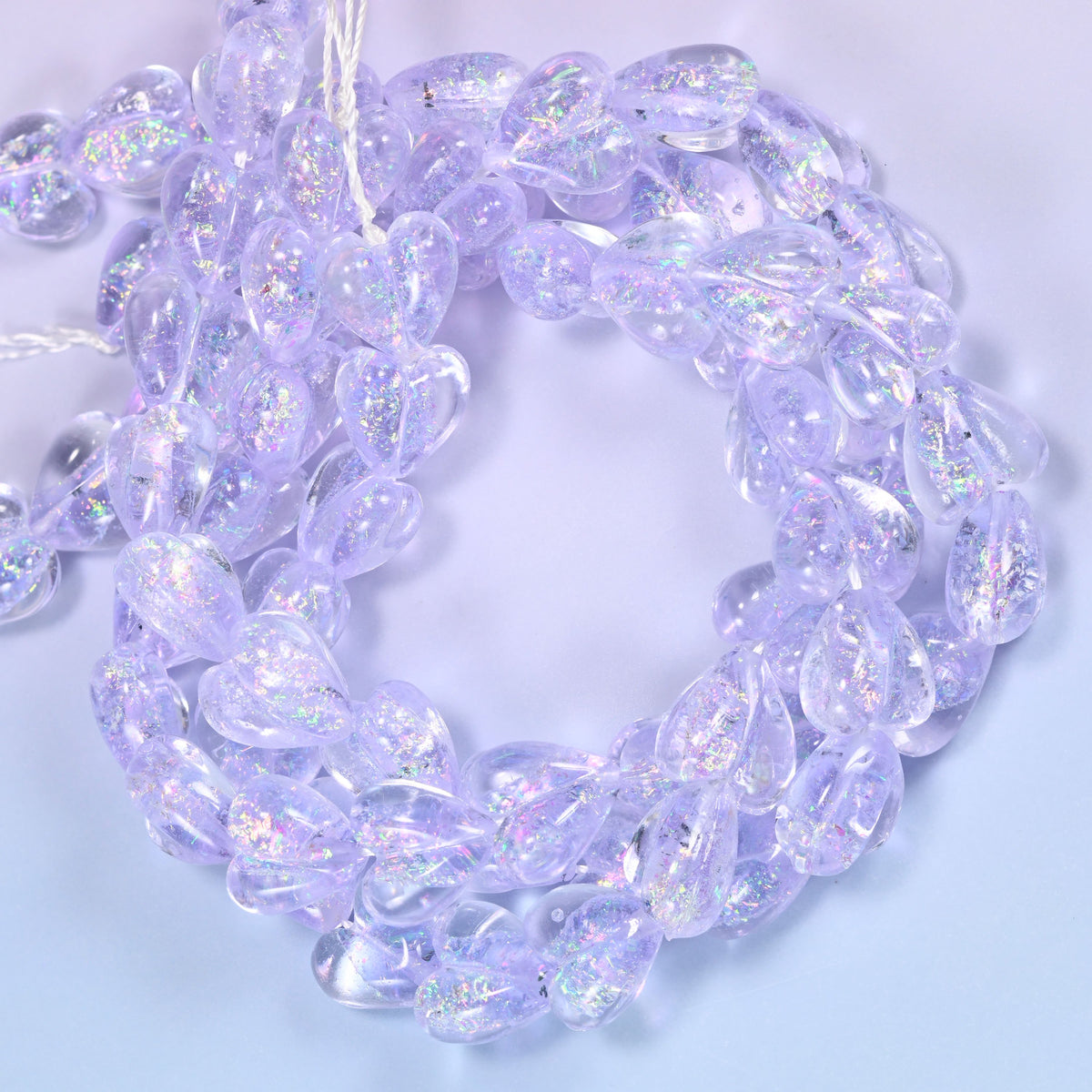Iridescent Light Purple Heart glass beads, close view of the coiled strands in soft lilac with glitter inclusions