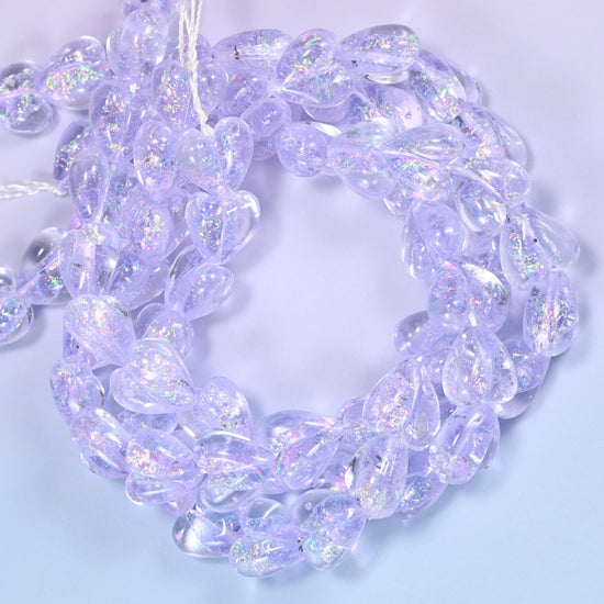 Iridescent Light Purple Heart glass beads, close view of the coiled strands in soft lilac with glitter inclusions