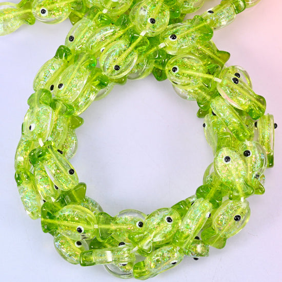 Iridescent Lime Green Fish glass beads, close view of the coiled strands in lime green with glitter inclusions