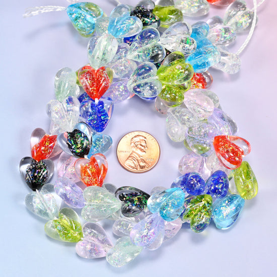 Iridescent Multicolor Heart glass bead strands coiled around a US penny for size reference