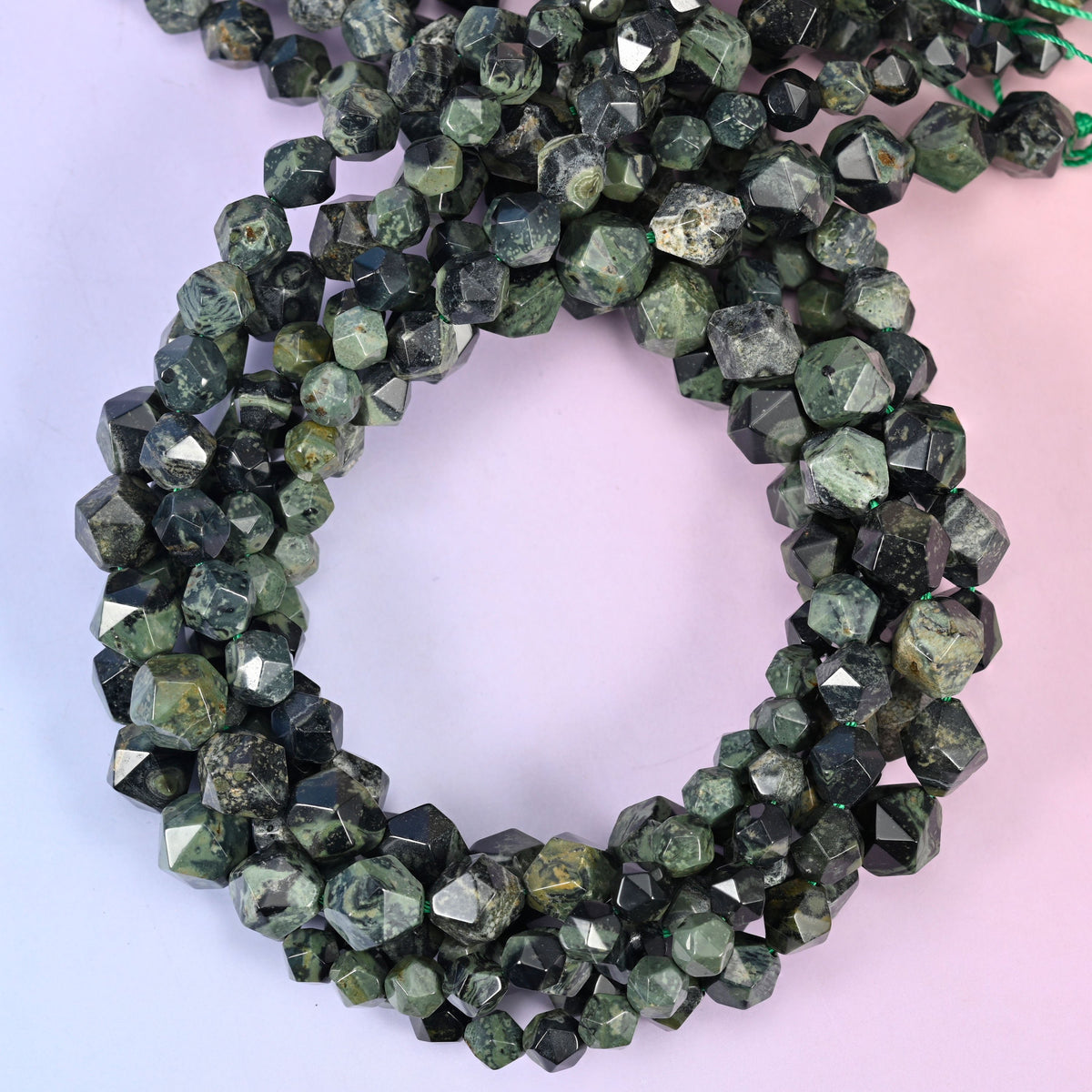 Kambaba jasper diamond star cut beads, several strands coiled into a loop.