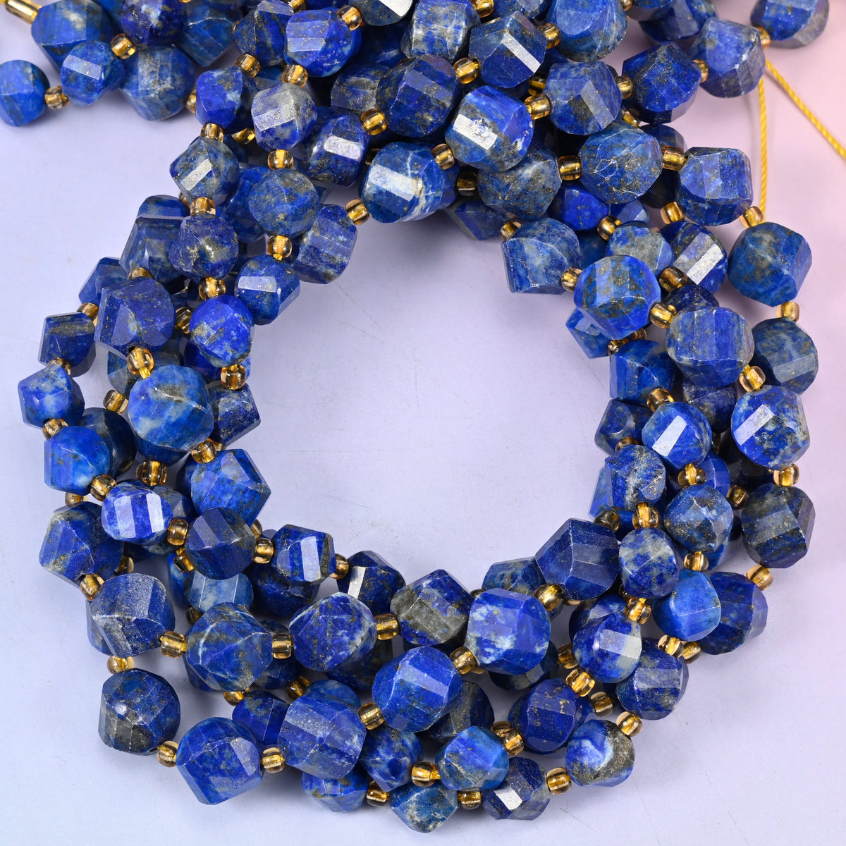 Lapis Lazuli faceted spiral twist beads, close view of the coiled strands showing deep blue with white and gold flecks