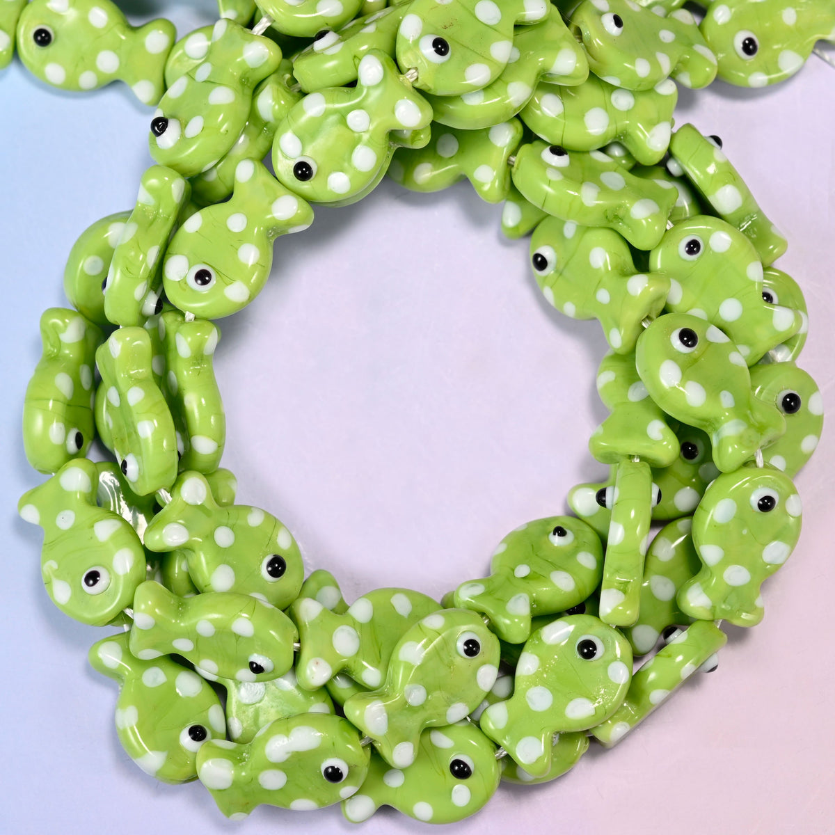 Lime Green with White Dot Fish glass beads, close view of the coiled strands in lime green with white spots