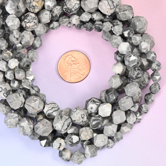 Map jasper faceted diamond star cut bead strands coiled around a US penny for size reference