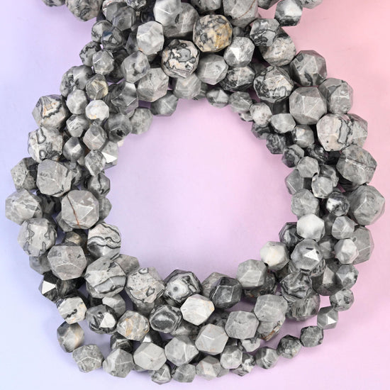 Map jasper faceted diamond star cut beads, strands coiled into a ring showing the pale grey stone with dark map-like veining