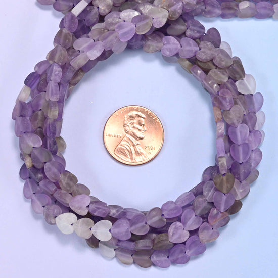 Amethyst flat heart-shaped beads from the 15 inch strand collection shown for bulk order planning