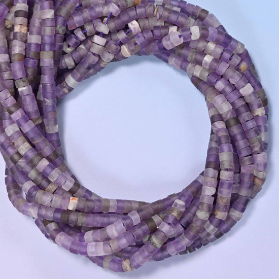 Matte Amethyst heishi disc beads, close view of the coiled strands showing purple with lighter grey-white bands
