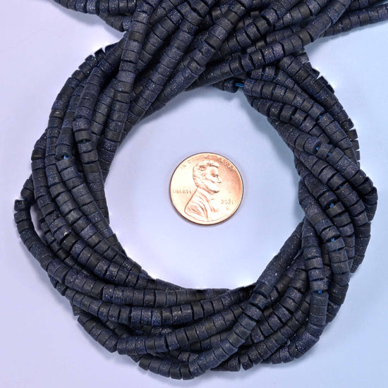 Matte Blue Sandstone heishi disc bead strands coiled around a US penny for size reference