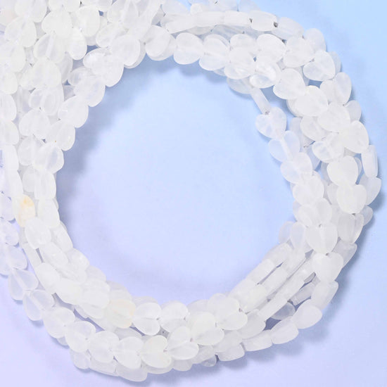 Matte Clear Quartz flat heart beads, close view of the coiled strands of frosted white hearts