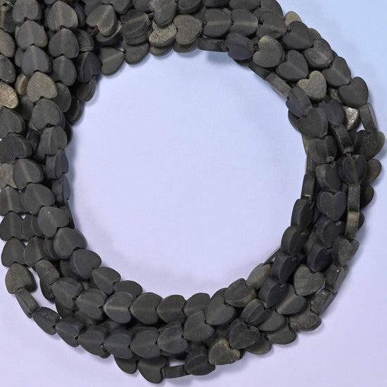 Matte Gold Obsidian flat heart beads, close view of the coiled strands in dark charcoal black with olive glints
