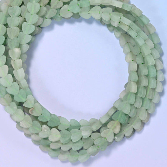 Matte Green Aventurine flat heart beads, close view of the coiled strands in soft sage green with a matte finish
