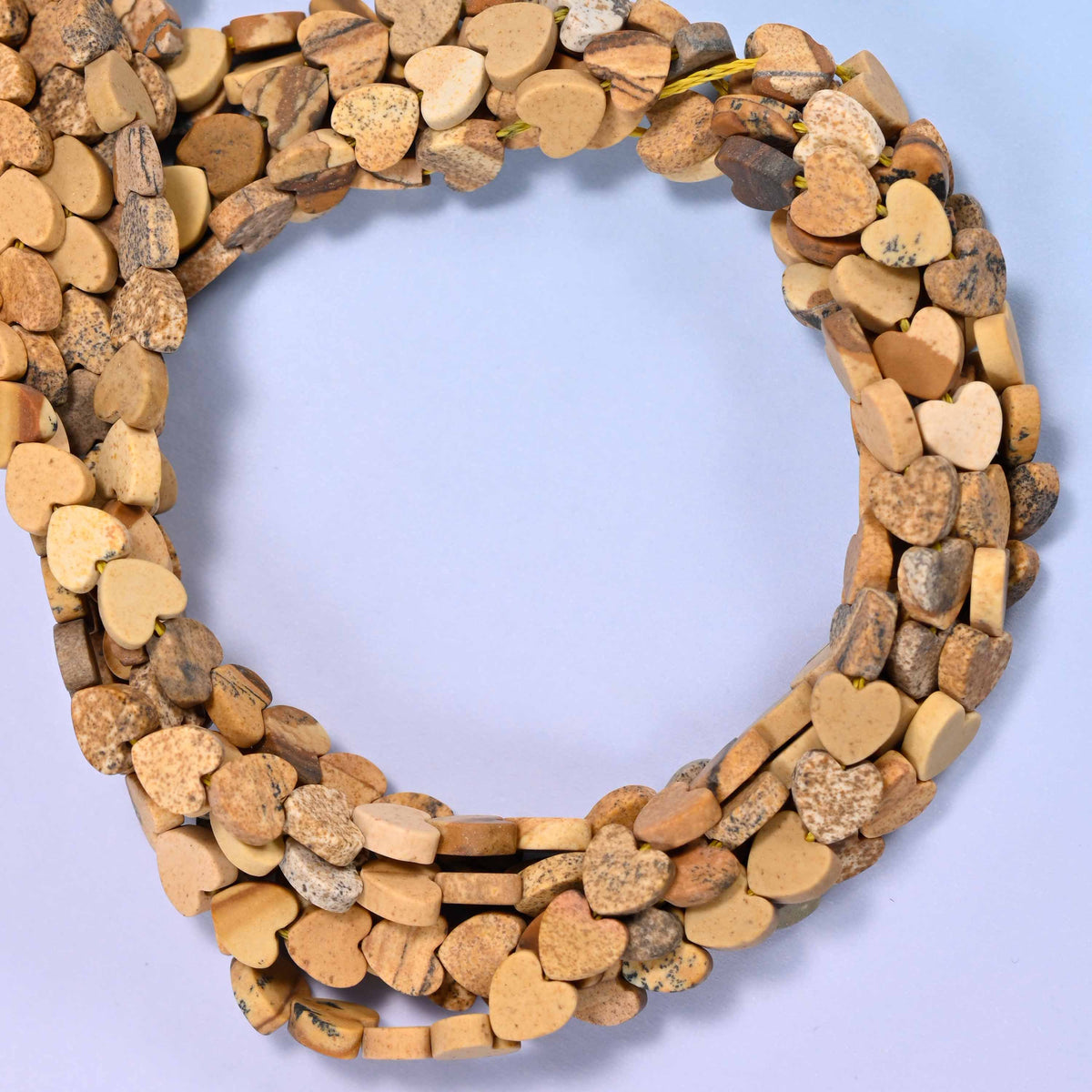 Matte Picture Jasper flat heart beads, close view of the coiled strands in tan and camel with brown markings
