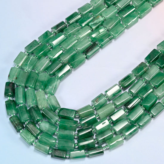 African jade faceted tube beads in several strands curved into a wide U, translucent green stone