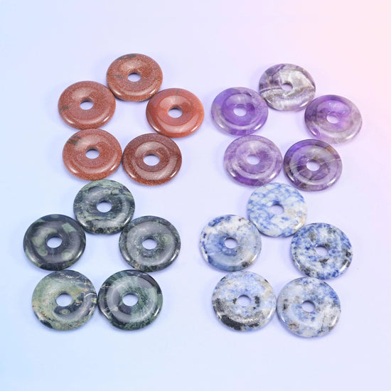 Rust red, lavender amethyst, dark grey and mottled blue donuts arranged in clusters