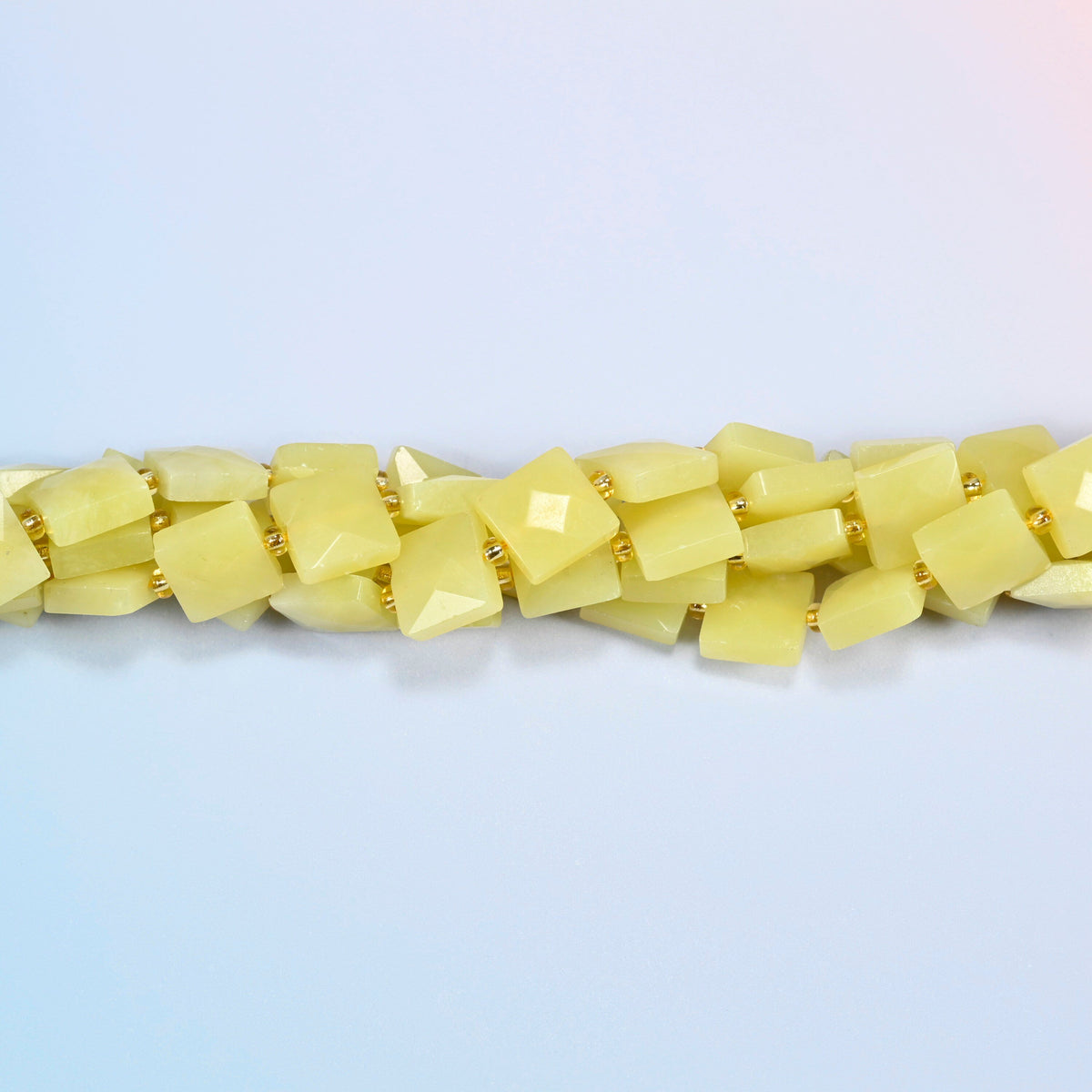 Strands of Lemon Jade faceted flat square beads twisted together in a horizontal row