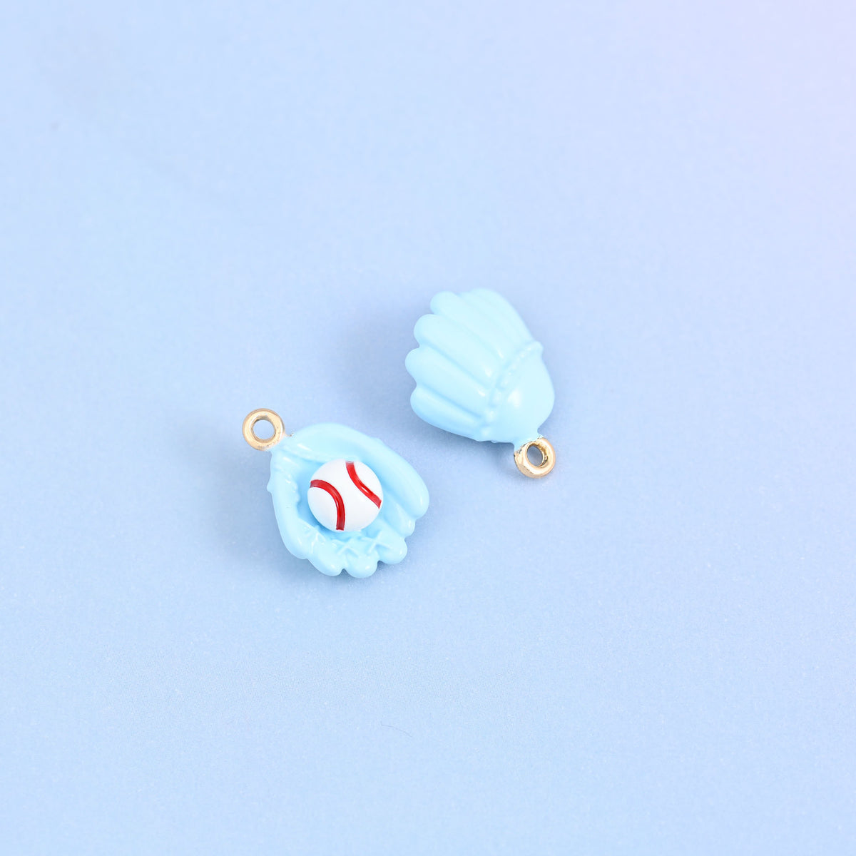 Two light blue baseball glove charms, front and back, white ball with red stitching in the pocket.
