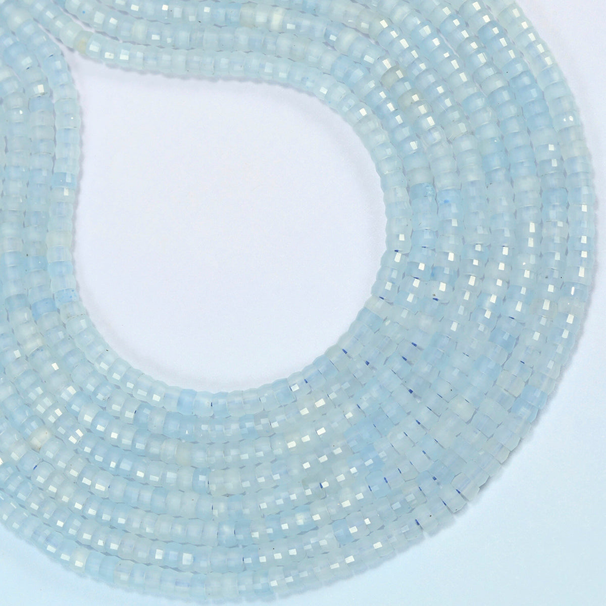 Aquamarine chalcedony faceted heishi disc beads curved into an open loop, light icy blue beads
