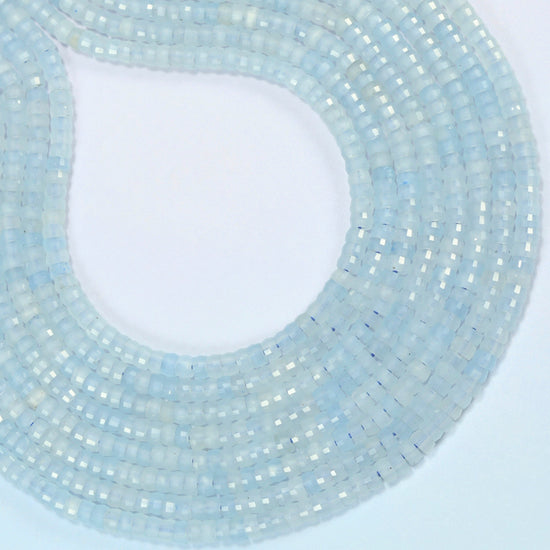 Aquamarine chalcedony faceted heishi disc beads curved into an open loop, light icy blue beads