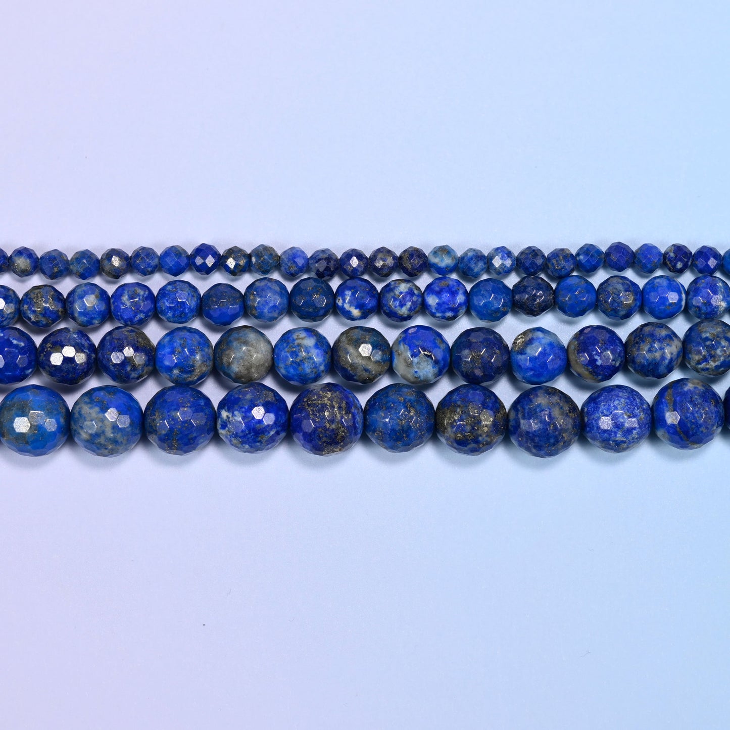 Lapis Lazuli faceted rounds shot through with gold pyrite and grey-white calcite.
