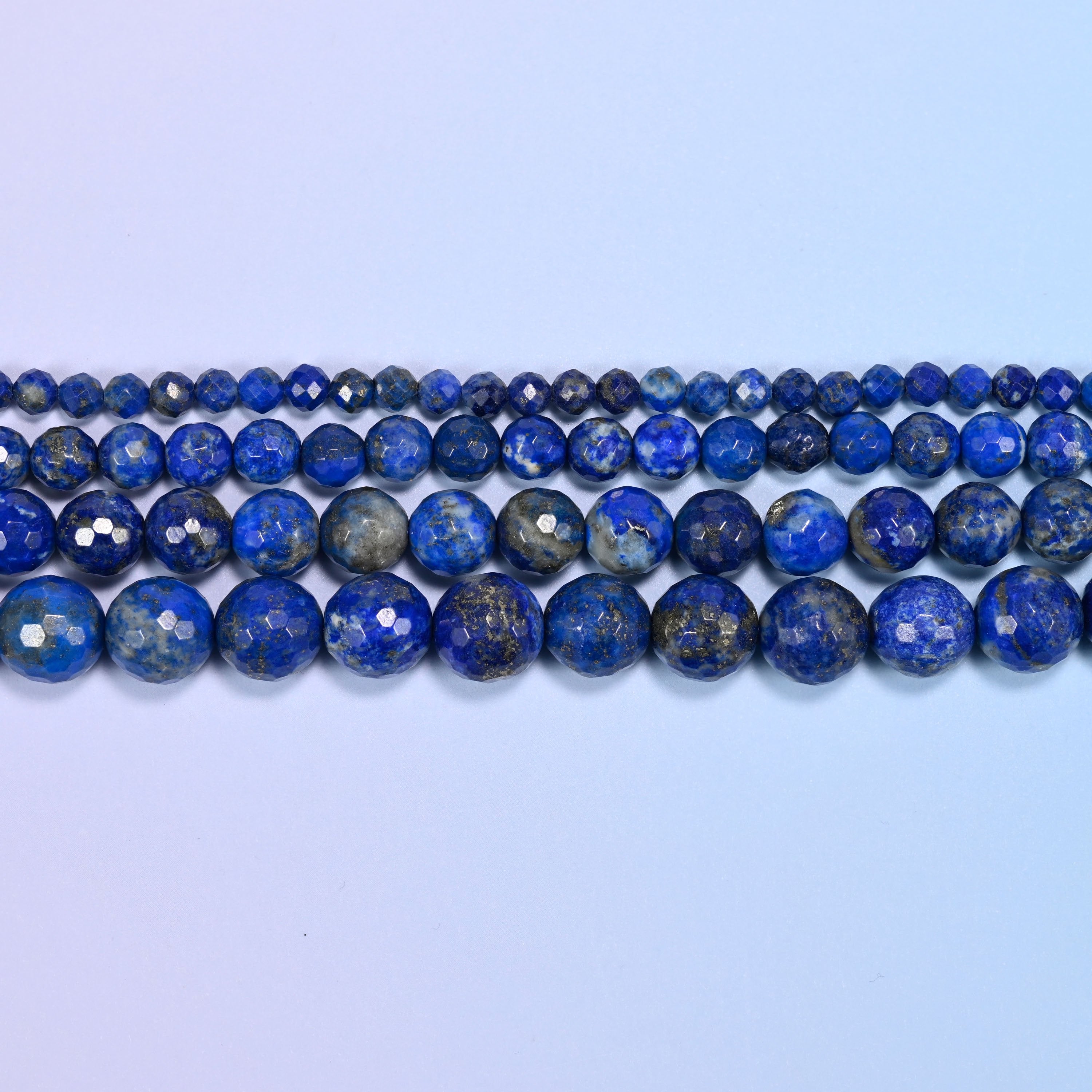 Lapis Lazuli faceted rounds shot through with gold pyrite and grey-white calcite.