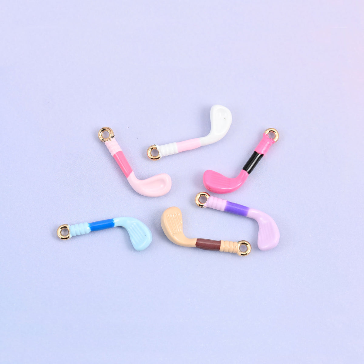 Six golf club charms scattered, one in each enamel color.